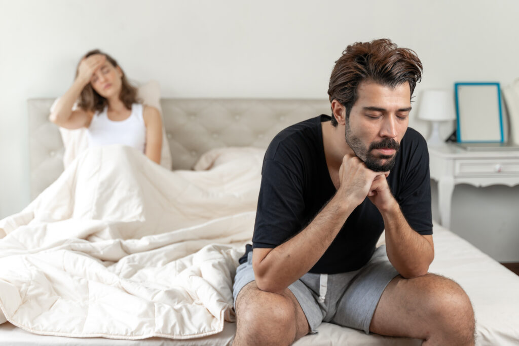 selective husband sitting bed with feel bored about her wife