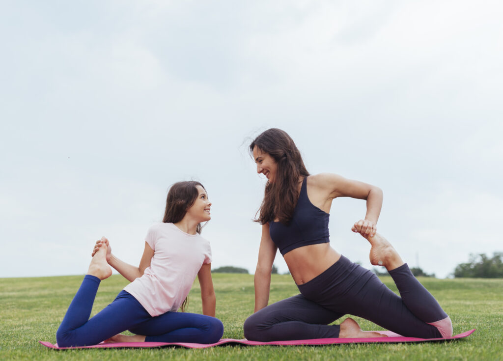 mother daughter doing exercises outdoors