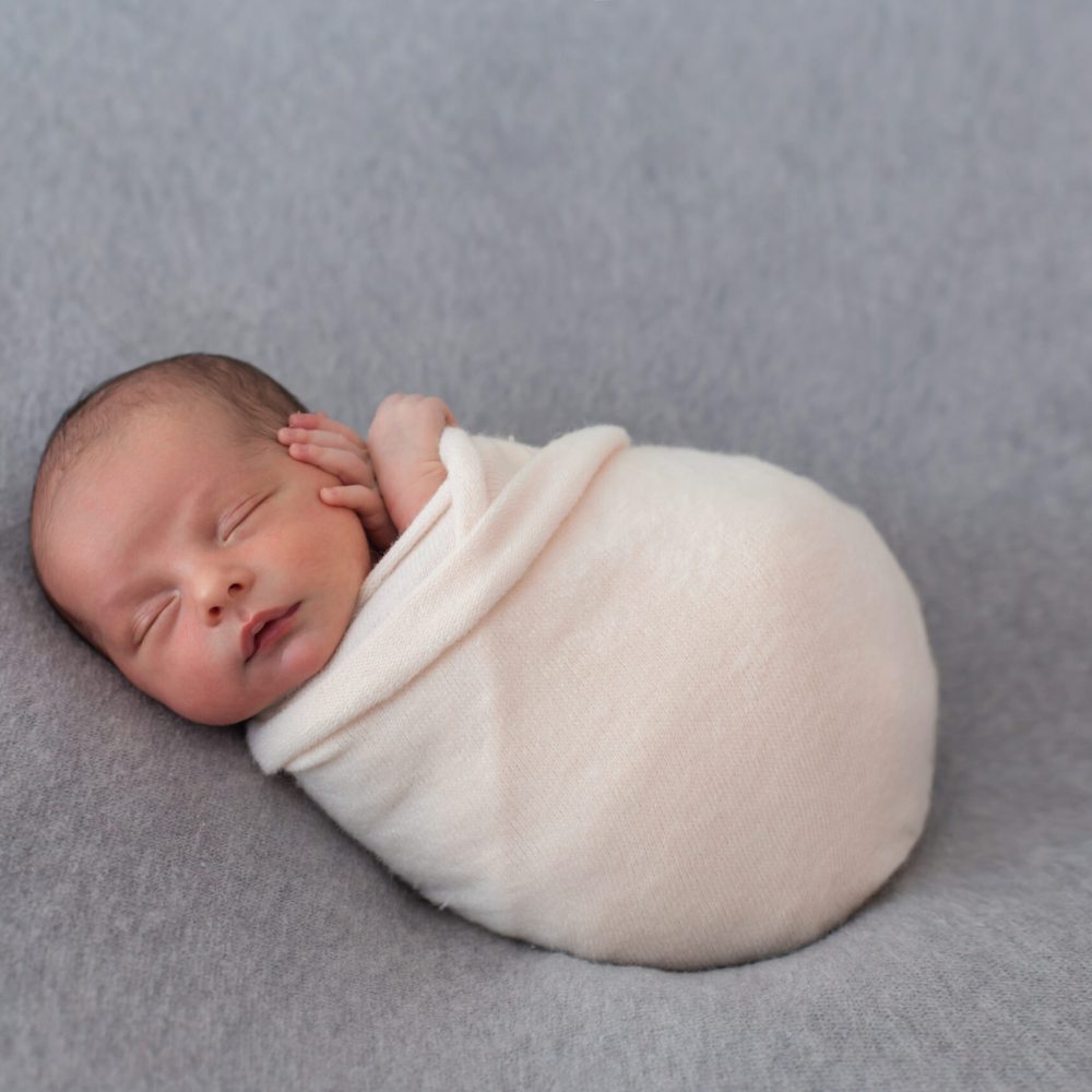 newborn-baby-wrapped-with-soft-pink-tissue